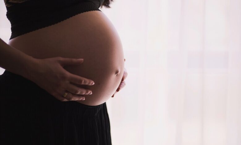Mujer embarazada sonriendo, con un título sobre la pregorexia