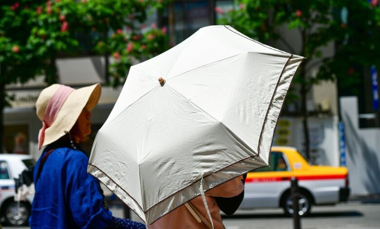 Persona paseando con un paraguas en la calle