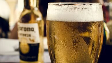 Persona bebiendo cerveza en la playa