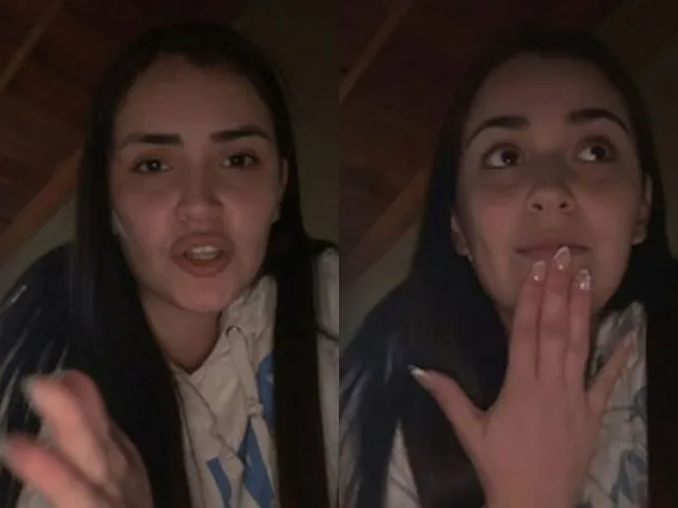 Una persona sentada en una silla, con la cabeza en las manos, mirando una pantalla de computadora con una expresión de tristeza