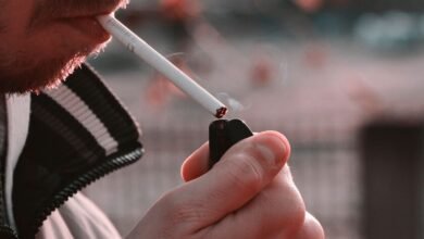 Adulto mayor fumando en una terraza, símbolo de la soledad vinculada al tabaco