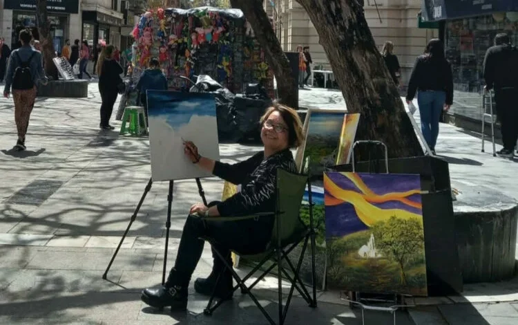 Esther Arrúa pintando en el cantero del Paseo de las Flores, Peatonal de Córdoba