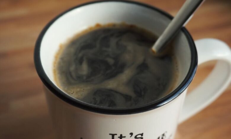 Taza de café humeante sobre mesa de madera en una cocina cordobesa